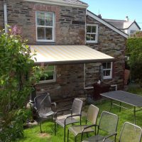 cream awning fitted to a period home