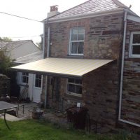 cream awning fitted to a period home